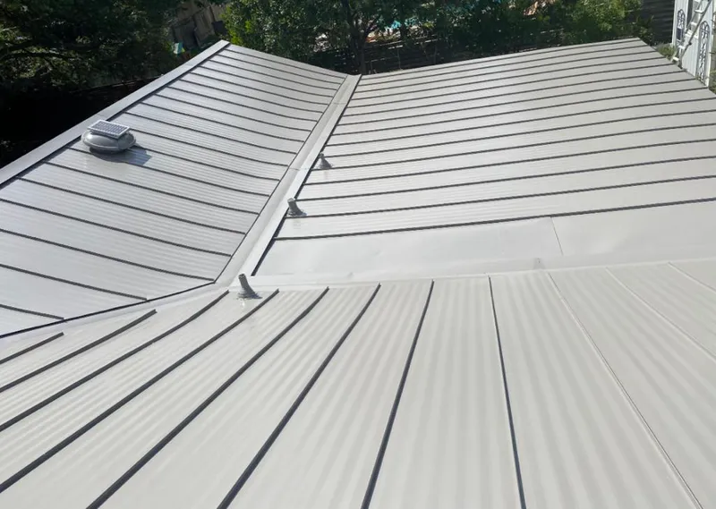 Solar attic fan installed on a metal roof for Roof Ventilation in Greensboro
